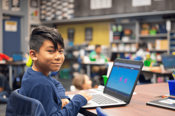 Boy playing ST Math games on a laptop