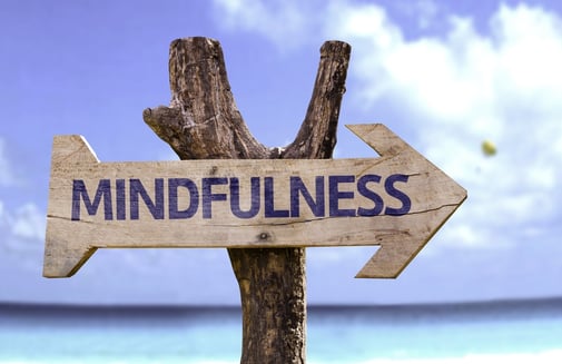 Mindfulness wooden sign with a beach on background.jpeg